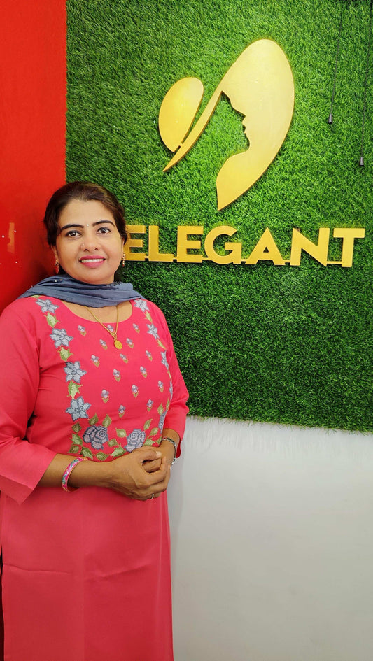 Woman wearing pink churidar set standing in front of Elegant The Style Sanctuary logo on green background