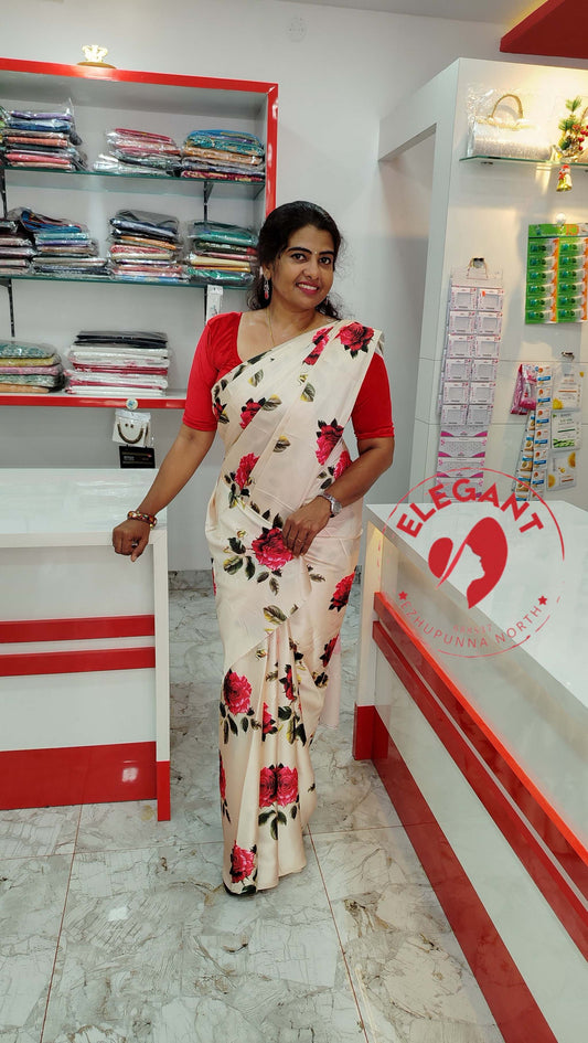 Woman wearing white Satin Silk Sarees with red floral print and red blouse standing in a clothing store