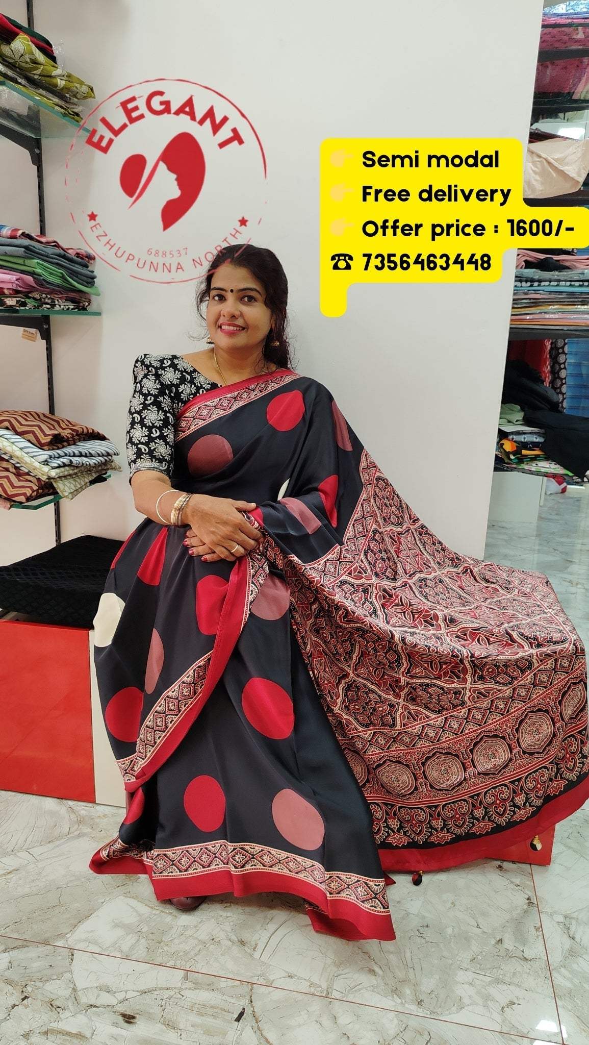 Woman wearing black and red semi modal silk saree with large circular patterns and intricate border, displayed at Elegant store with offer details.