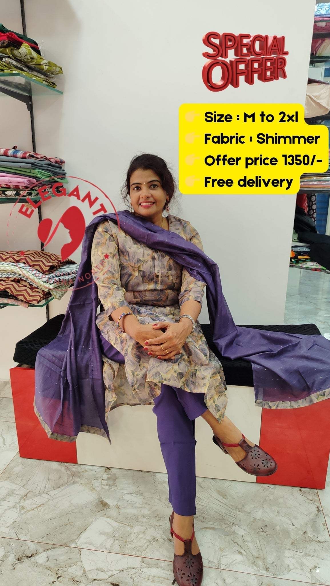 Woman wearing a shimmer fabric purple churidar set sitting on a red bench with a special offer sign displaying size and price details in a clothing store.