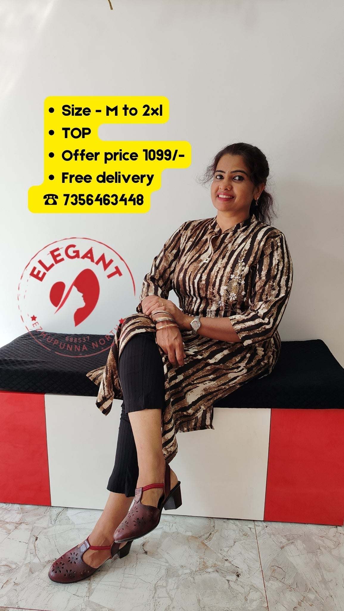 Woman wearing imported crepe top with animal print sitting on black and red bench.