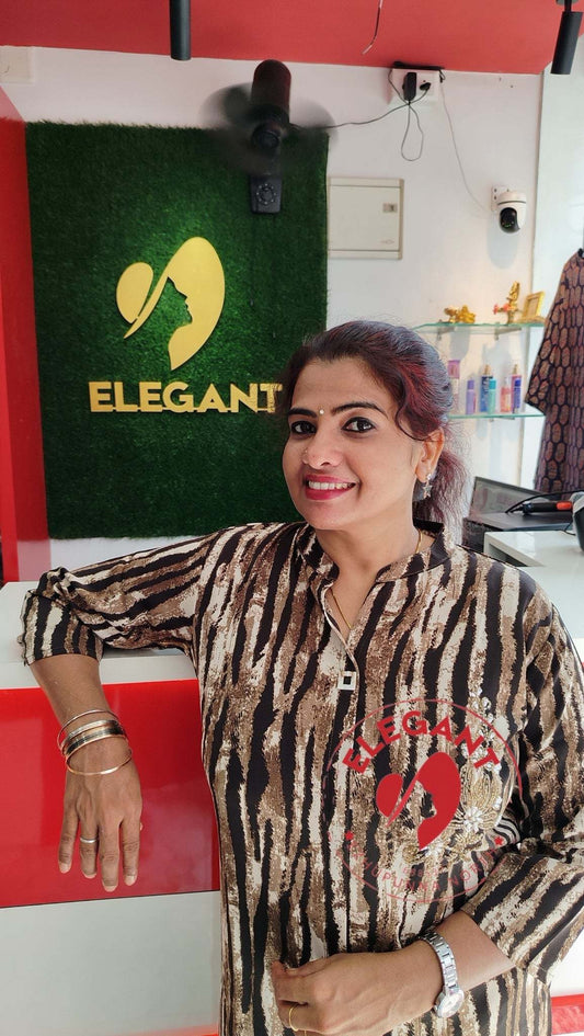 Woman wearing an imported crepe top with a stylish animal print pattern standing in a boutique labeled Elegant