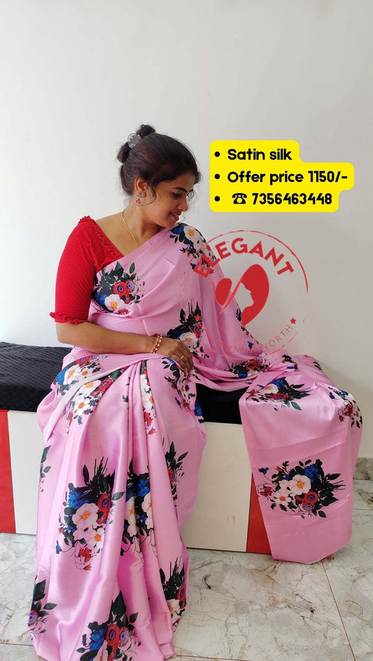 Woman wearing pink satin silk saree with floral print sitting on a bench