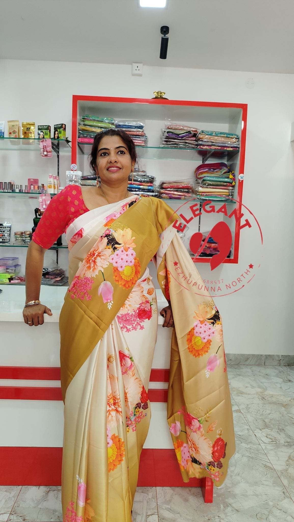 Woman wearing a floral satin silk saree in a store display showcasing satin silk sarees.