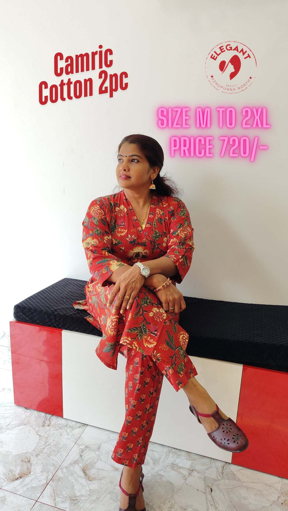 Woman wearing red floral Kurthi Set sitting on a black and red bench in a casual pose