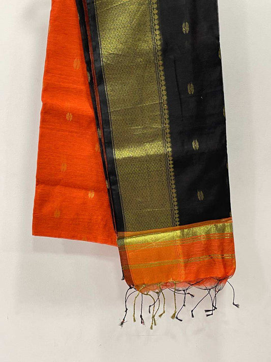 Traditional saree with orange, black, and gold patterns on a white background