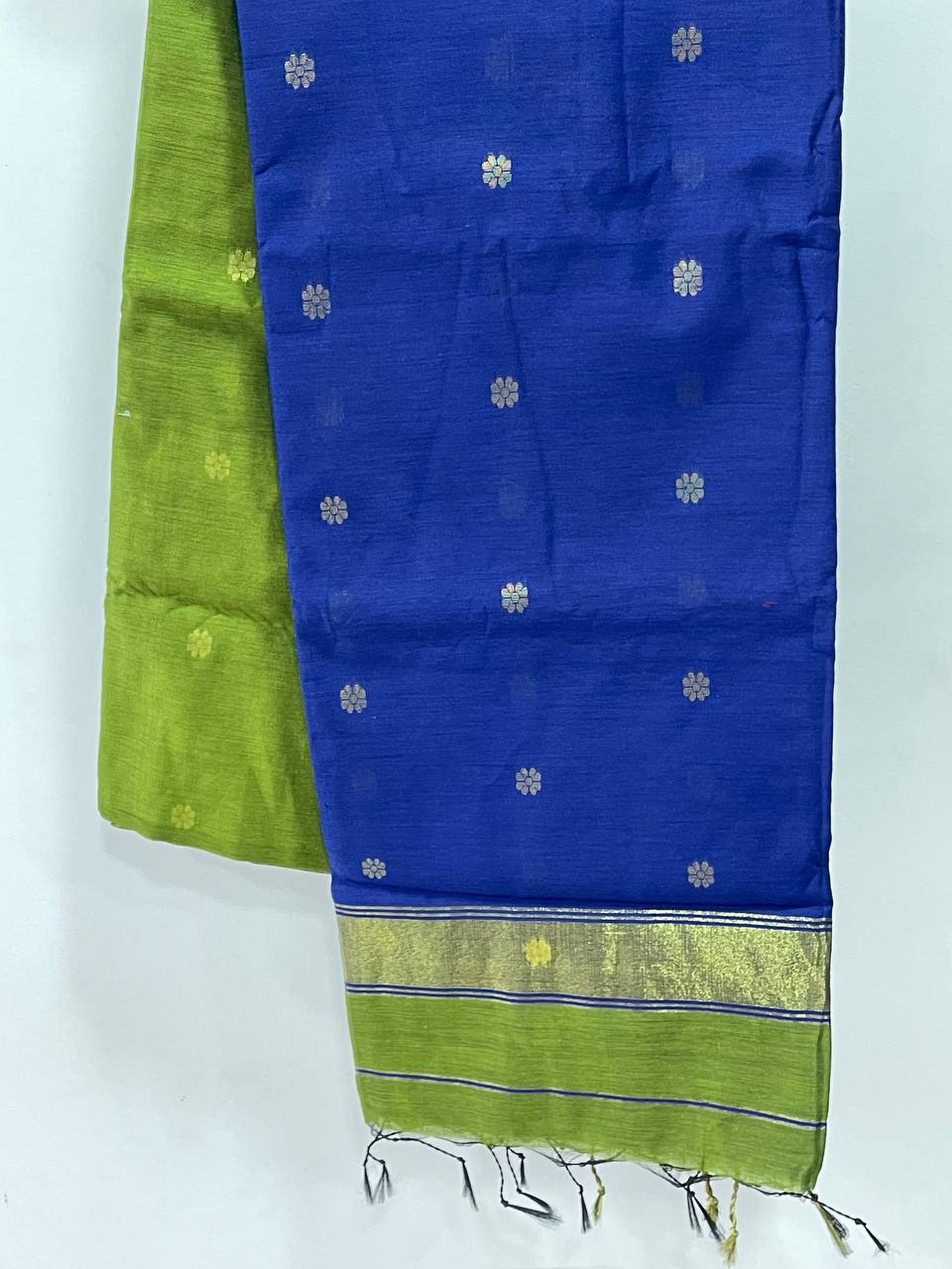 Blue and green fabric with floral patterns on a white background