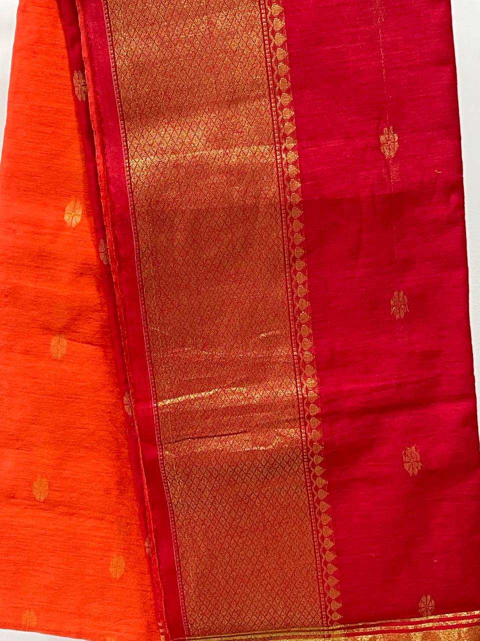 Red and orange saree with gold border on a white background