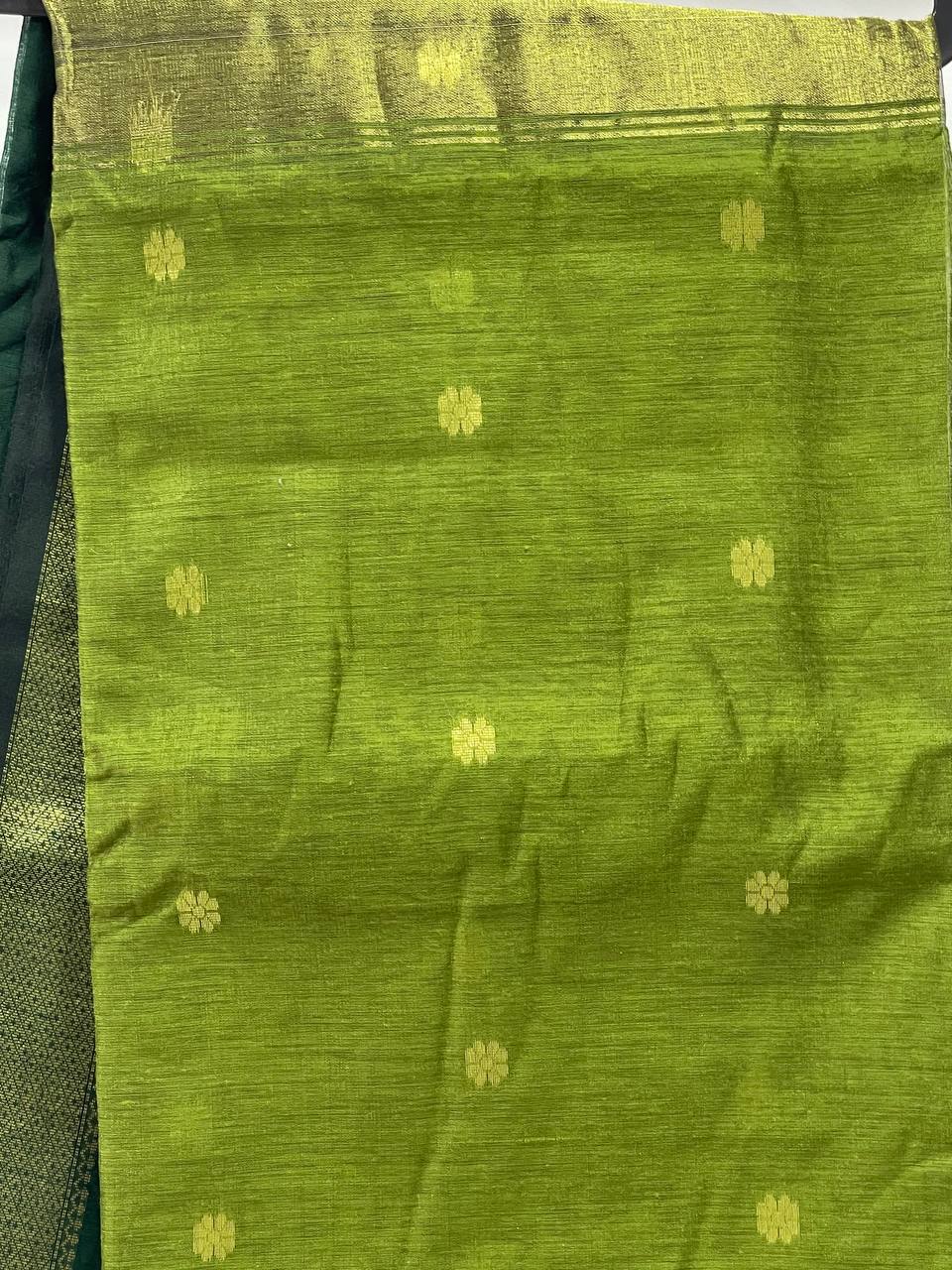 Green fabric with gold patterns on a black background