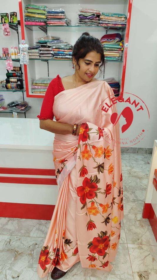 Woman wearing floral satin silk saree in clothing store showcasing elegant saree designs