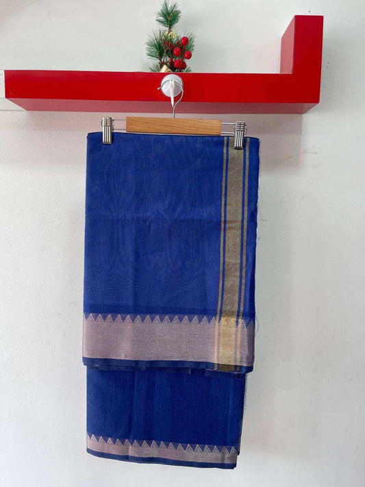 Dark blue soft silk saree with gold zari border hanging on wooden hanger against white wall