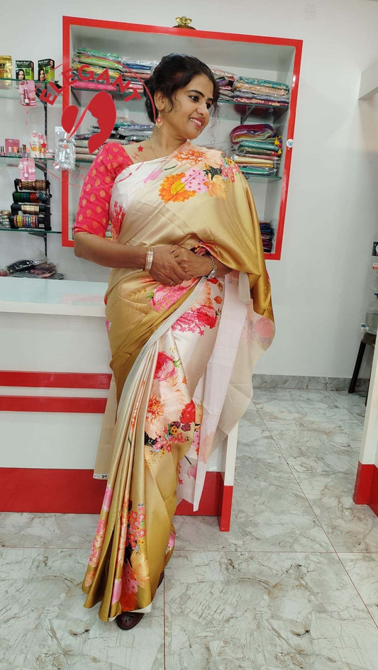 Woman wearing a golden floral satin silk saree with a pink blouse in a store setting