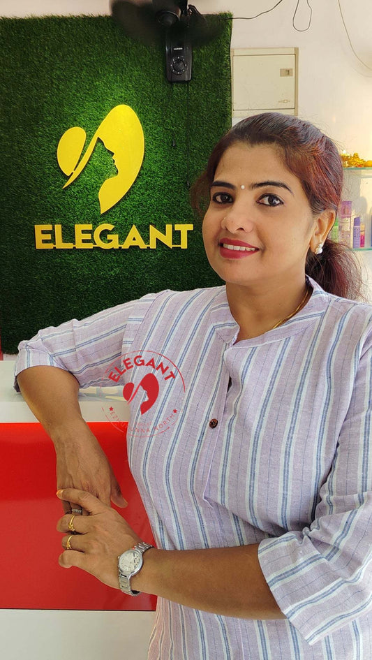 Woman wearing a high-quality khadi kurthi set with traditional and modern design elements posing indoors near a sign that says Elegant