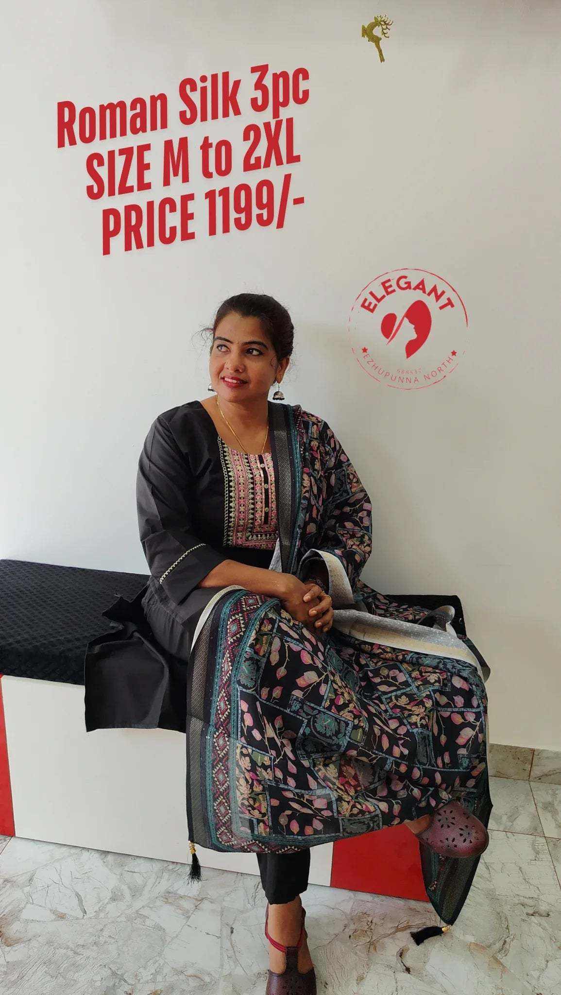 Woman wearing elegant Roman Silk churidar set with floral patterns sitting on bench, promoting 3-piece outfit available in sizes M to 2XL.
