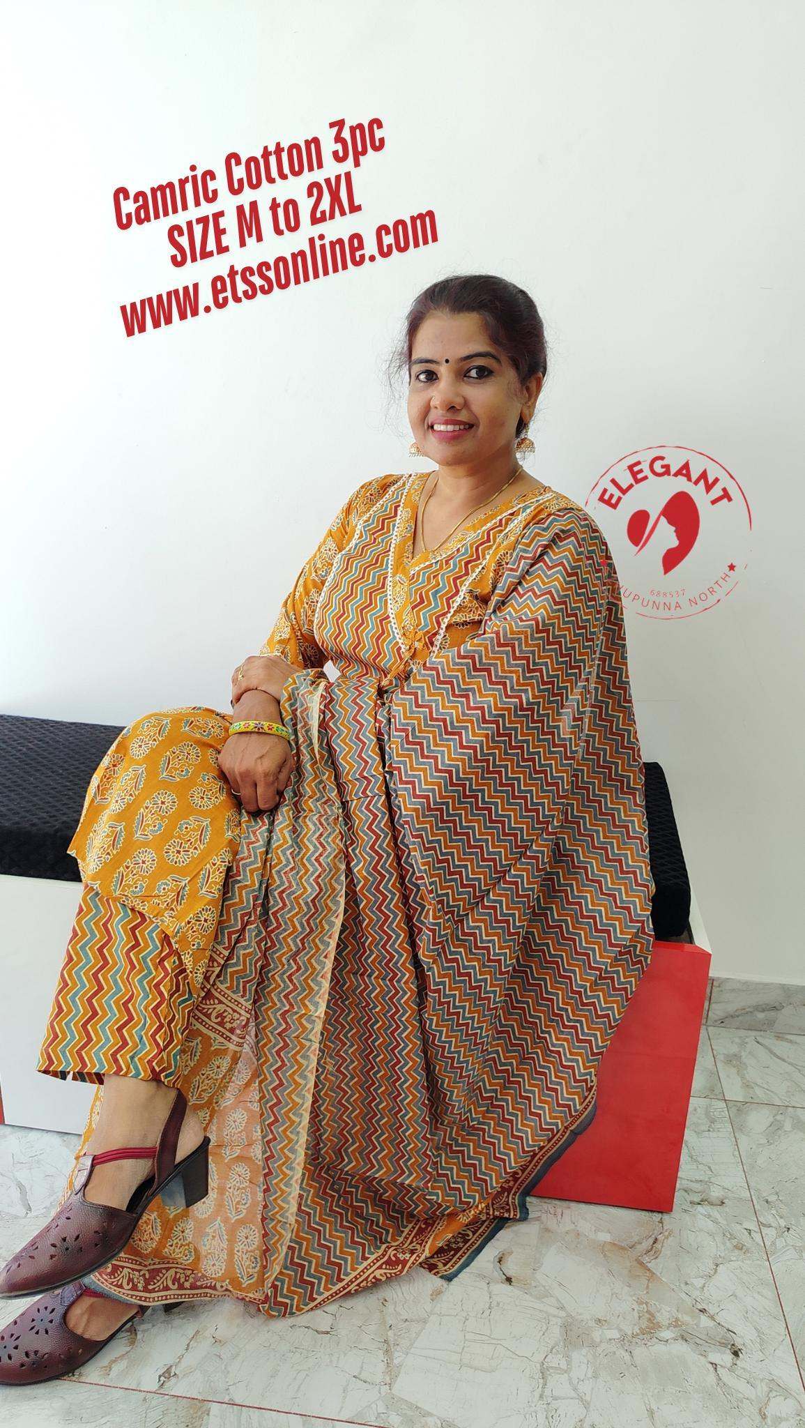 Woman wearing a yellow cotton churidar set with zigzag and floral patterns sitting indoors on a black and red bench
