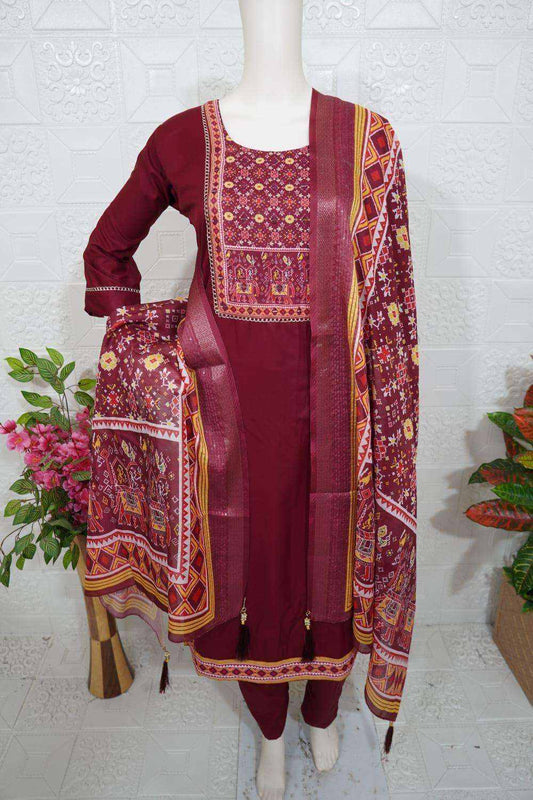 Maroon Roman Silk Churidar with intricate embroidery and matching patterned dupatta displayed on mannequin