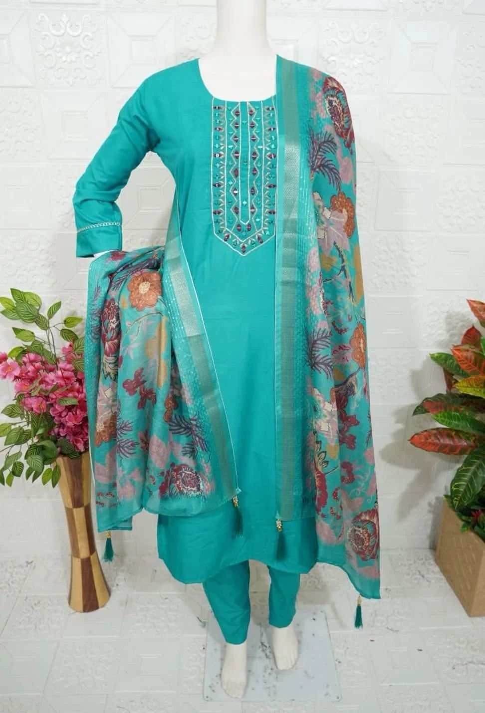 Roman Silk Churidar in teal with embroidered neckline and floral printed dupatta on mannequin