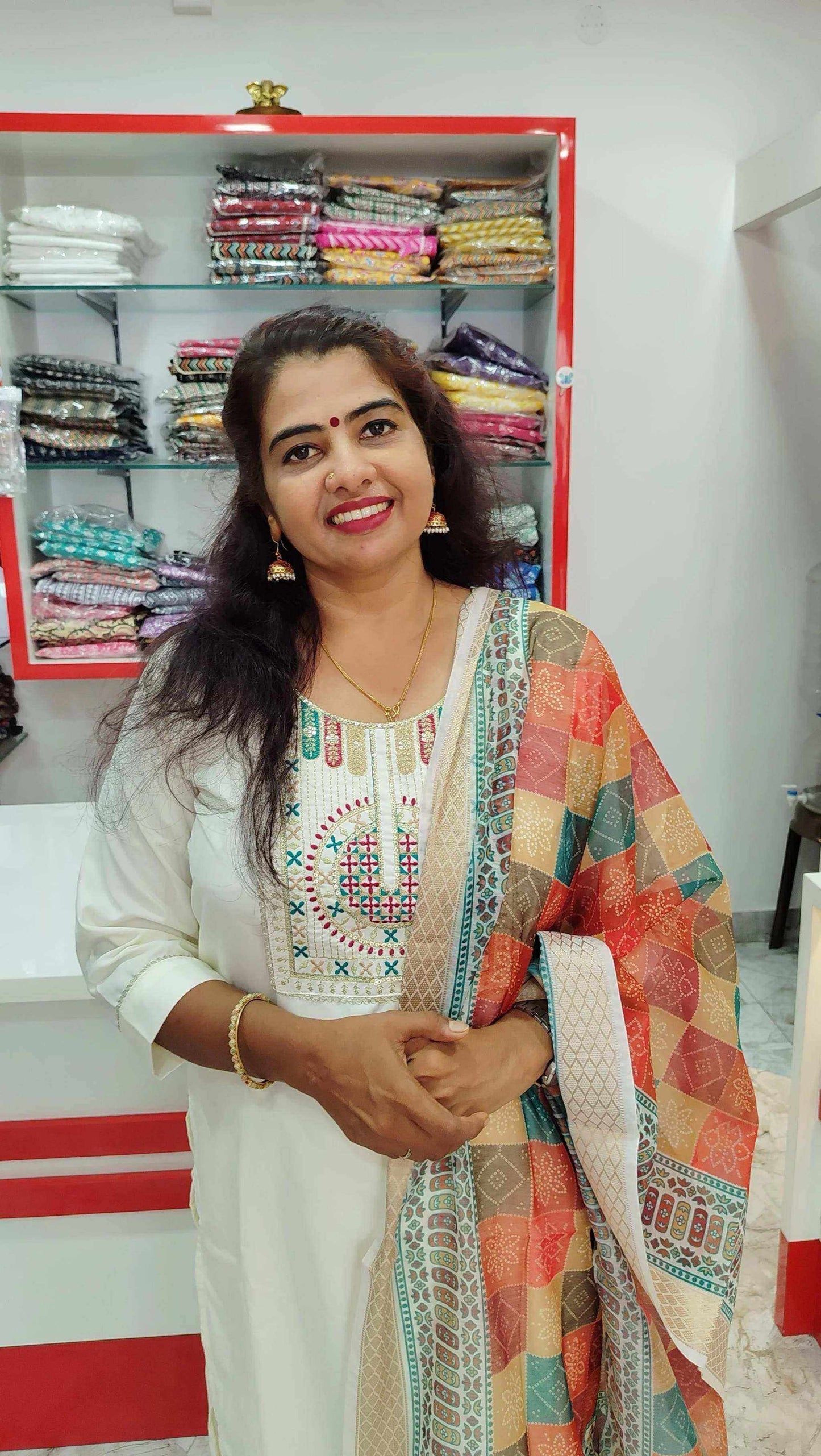 Woman wearing elegant Roman Silk Churidar with colorful patterned dupatta in fabric store