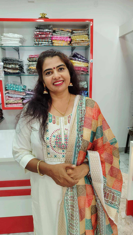 Woman wearing elegant Roman Silk Churidar with colorful patterned dupatta in fabric store