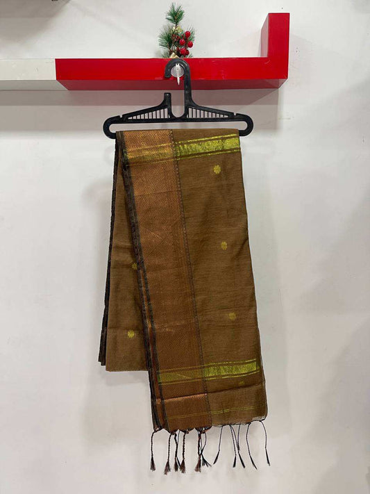 Brown saree with green accents on a hanger against a white background