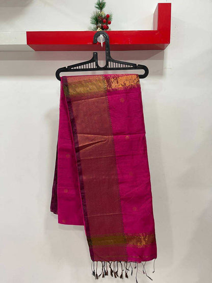 Pink and brown saree with a red shelf in the background