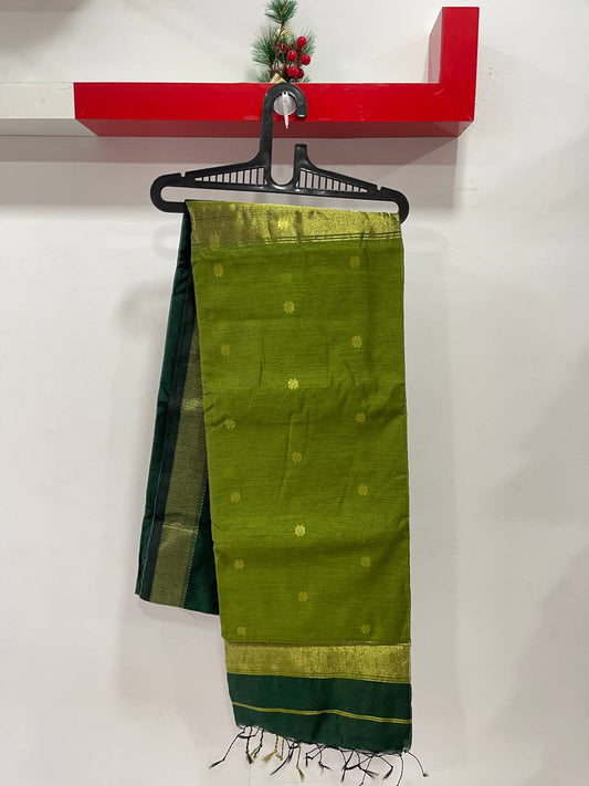 Green saree with a red shelf in the background