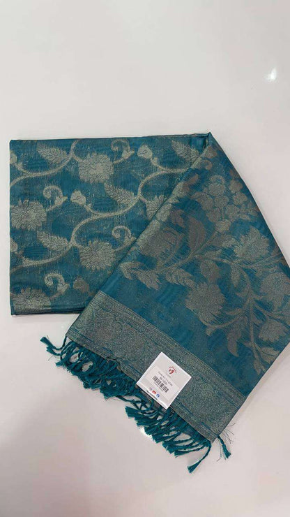 Blue semi Banarasi silk saree with intricate golden floral patterns and tassel fringe.
