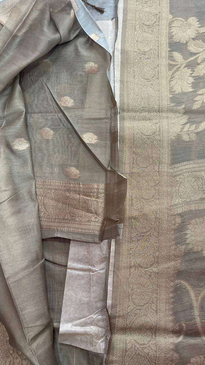 Semi Banarasi silk saree with intricate floral and paisley woven patterns in muted beige and grey tones, suitable for occasion and party wear.